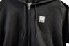 Black hoodie with a small white logo on the chest
